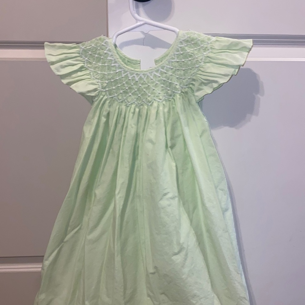 Light green smocked dress with pearl accent